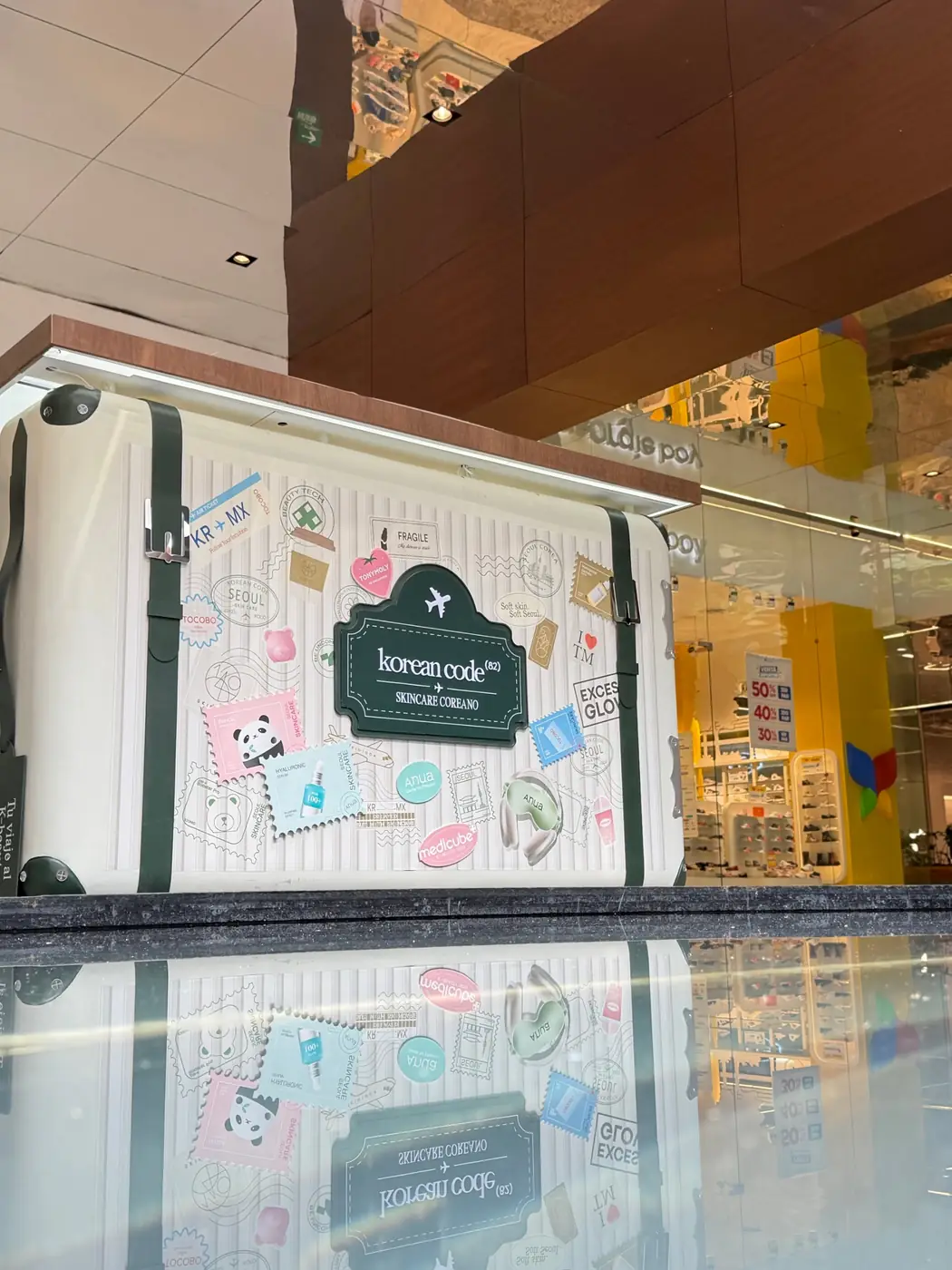 Detalle de la maleta de Korean Code con sellos y stickers de marcas